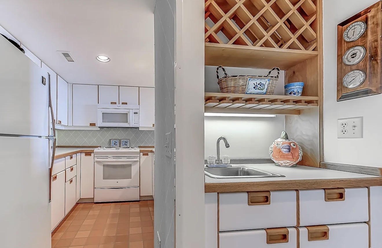 Kitchen before JICON remodel — dated cabinets, blue bar and worn finishes